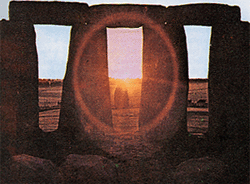 image of sun shining through the stones of Stonehenge