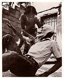 image of a girl helping a man with a skull-mask on
